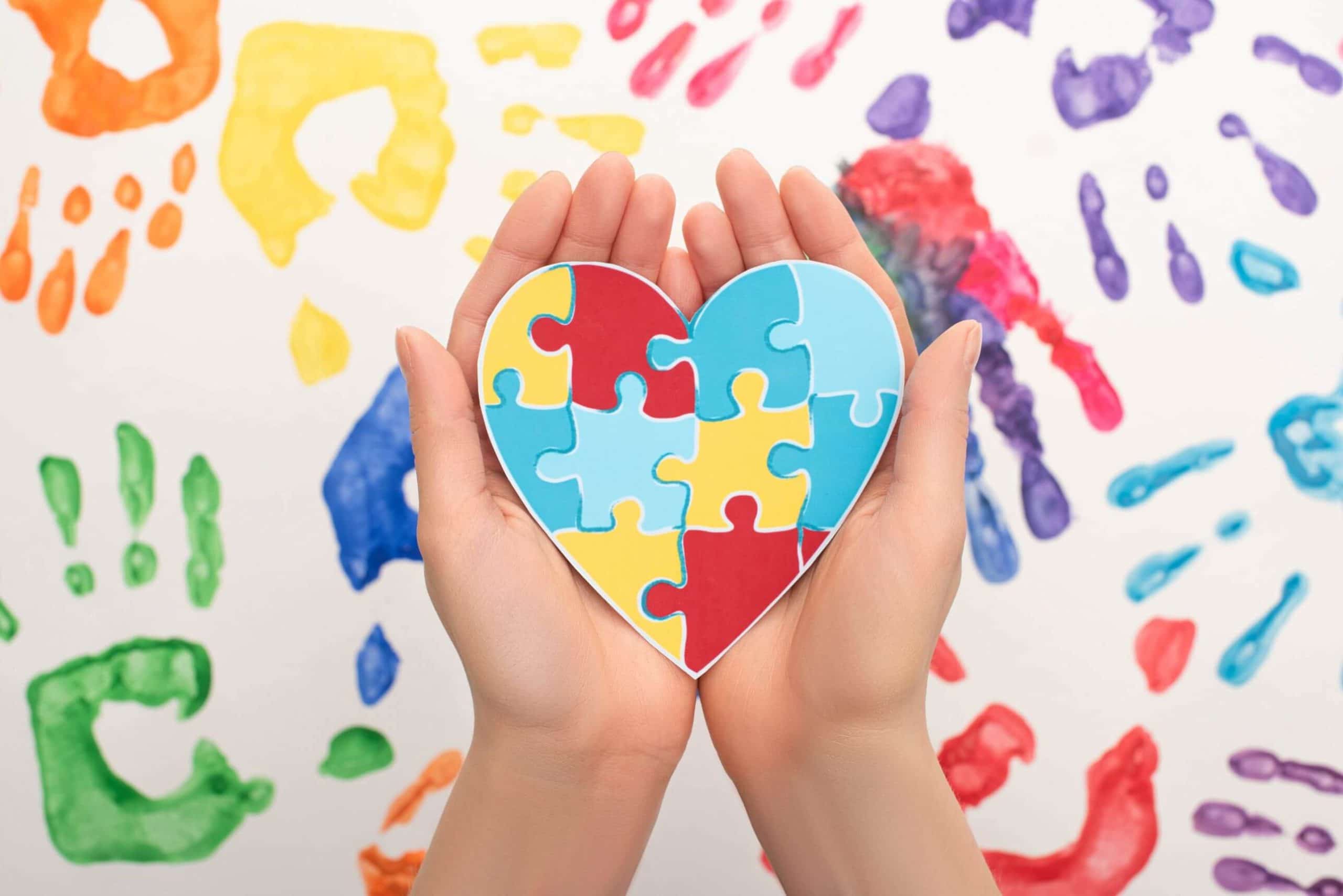 Woman holding a puzzle shaped heart.