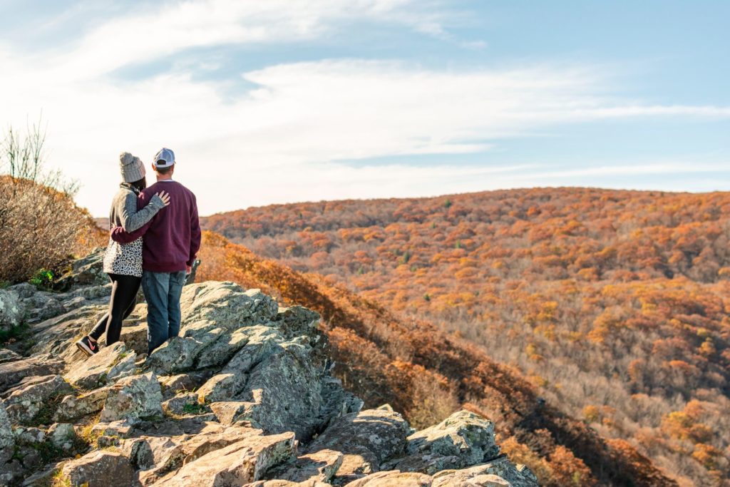 Couple hugging while taking a hike.